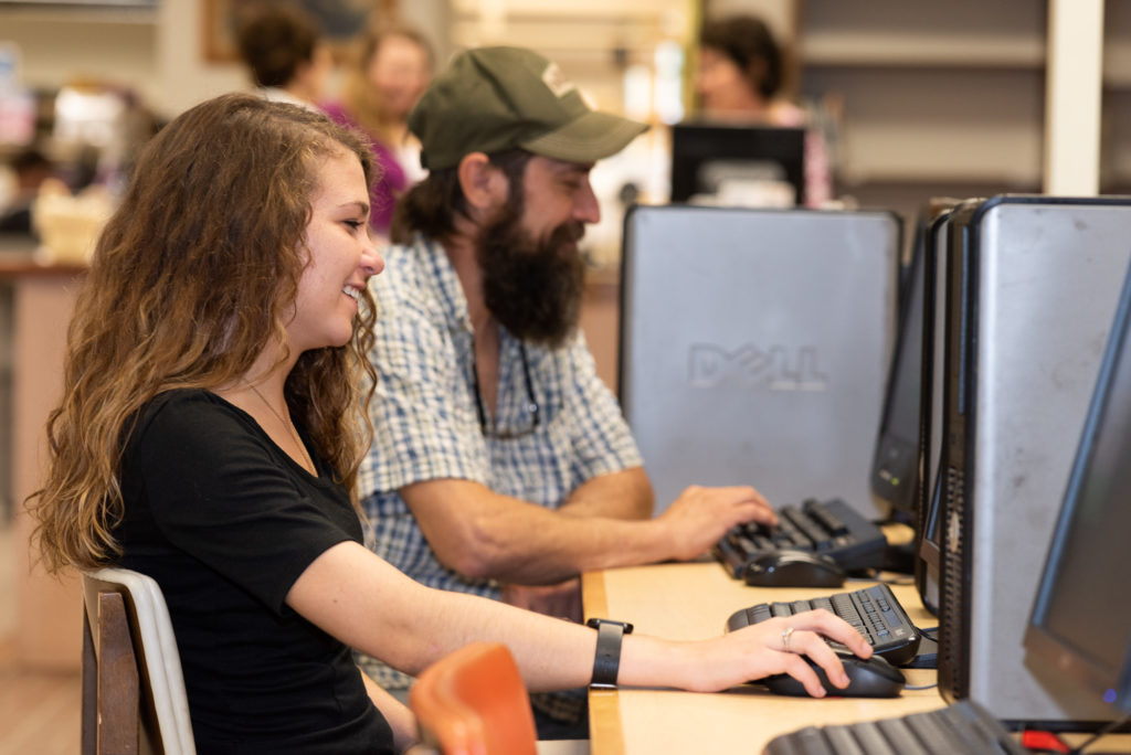 Man and woman using public computers at LaVale Library. 