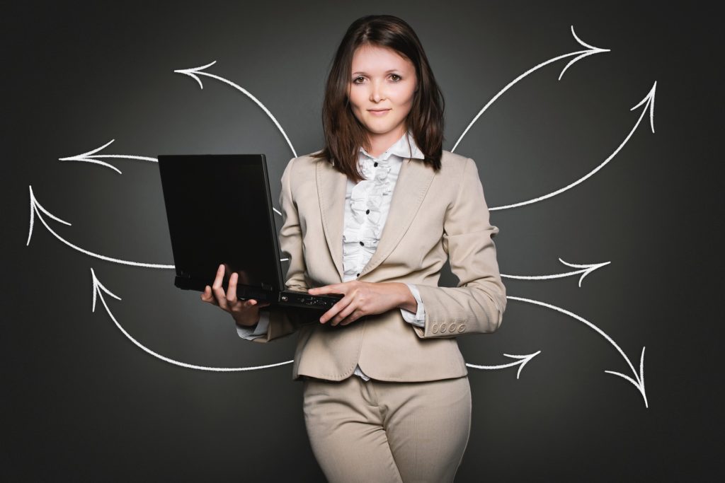 Woman holding laptop with arrows connecting to other directions. 