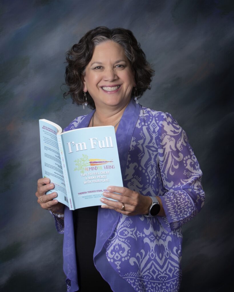 Photo of author, Theresa Stahl holding a copy of I'm Full. 