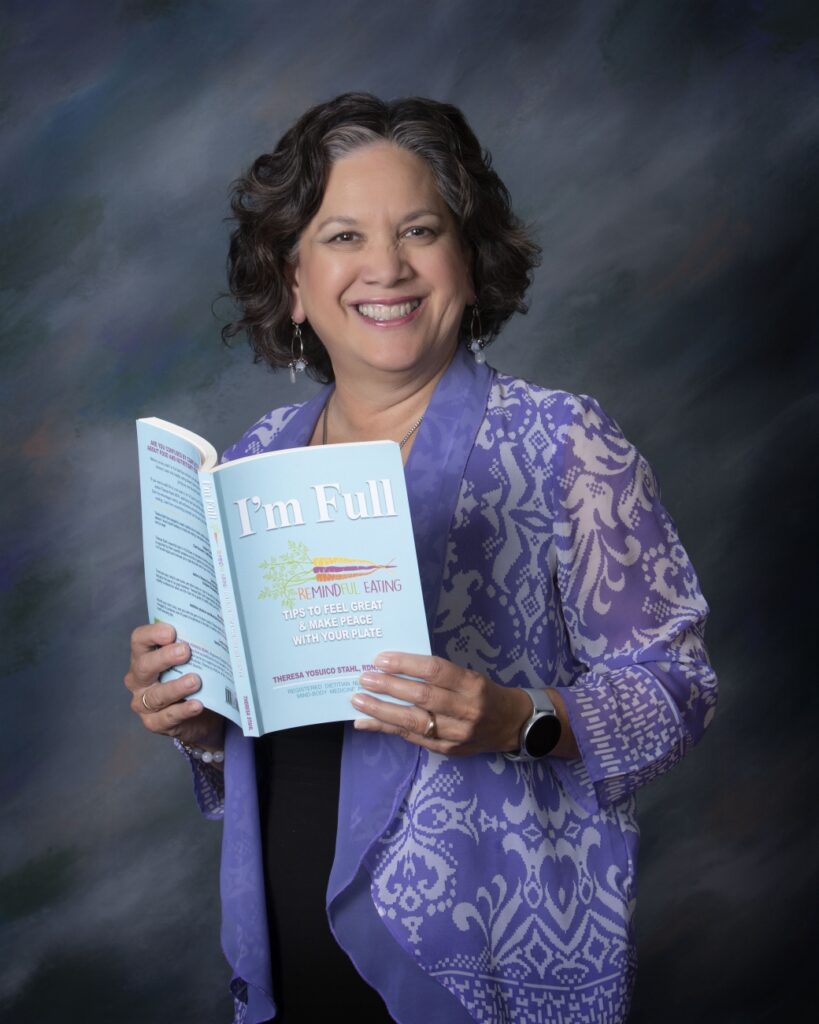 Photo of author, Theresa Stahl holding a copy of I'm Full.